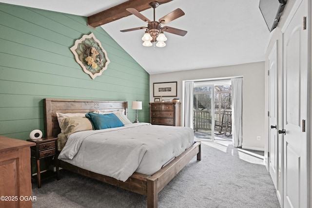 carpeted bedroom with lofted ceiling with beams, access to outside, wooden walls, and ceiling fan