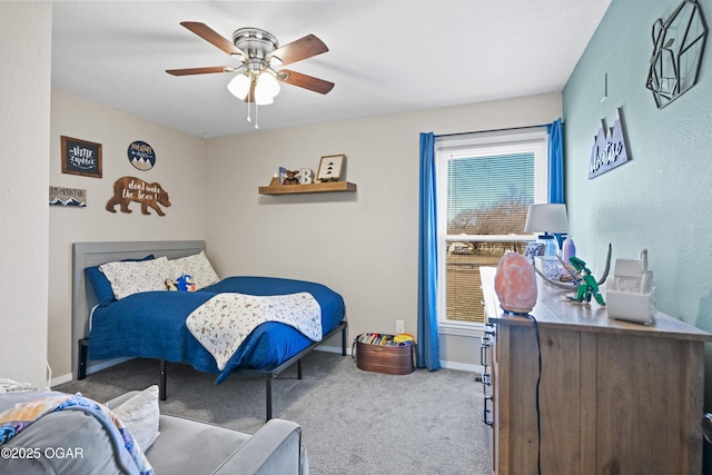 carpeted bedroom featuring baseboards and a ceiling fan