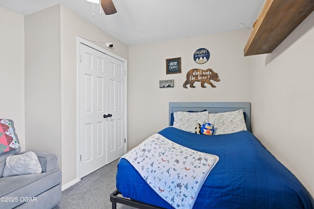 carpeted bedroom featuring a ceiling fan and a closet