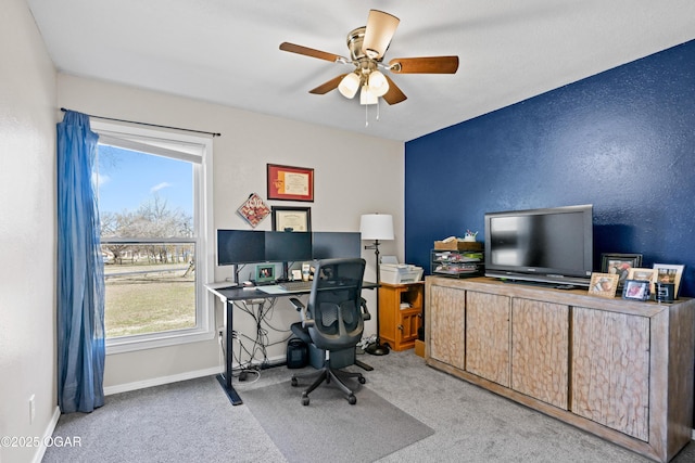 office area with baseboards, carpet floors, and a ceiling fan