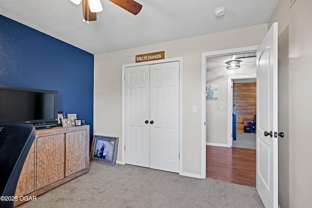 carpeted office featuring baseboards and ceiling fan