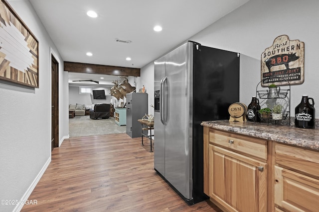 kitchen with visible vents, baseboards, stainless steel fridge with ice dispenser, recessed lighting, and light wood-style floors