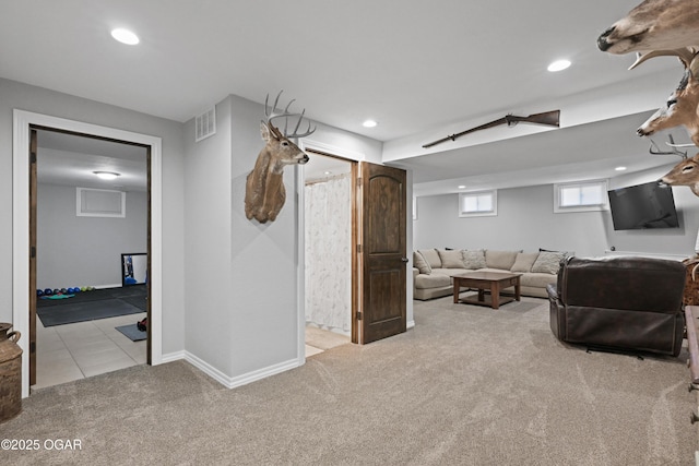 carpeted living area featuring recessed lighting, visible vents, and baseboards