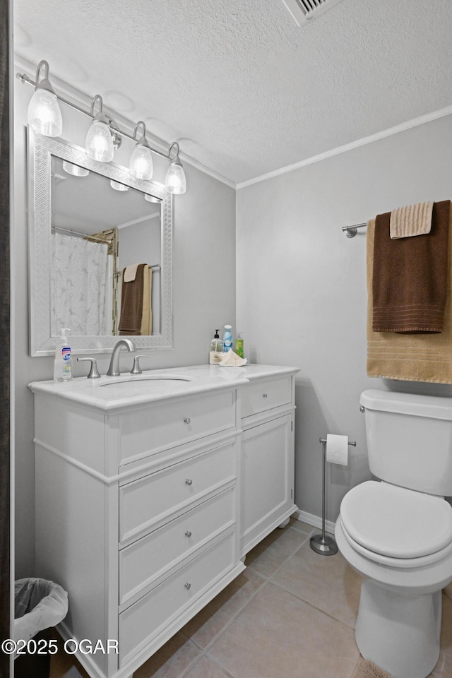 full bath with baseboards, toilet, vanity, tile patterned floors, and a textured ceiling