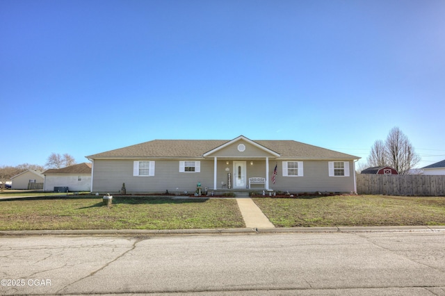 ranch-style house with a porch, a front lawn, and fence