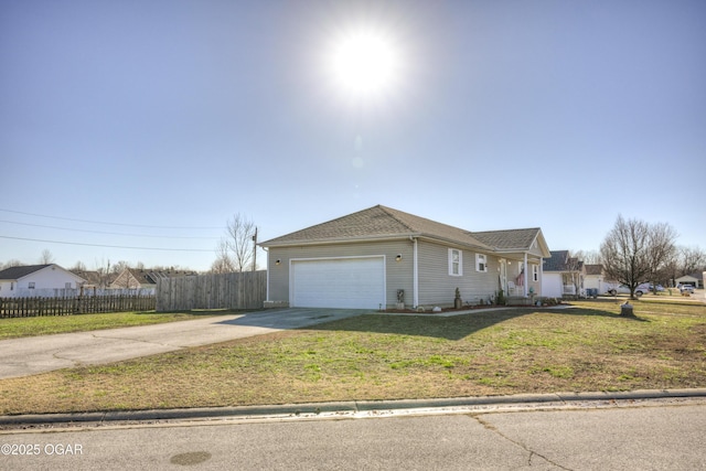 single story home featuring fence, roof with shingles, concrete driveway, an attached garage, and a front yard