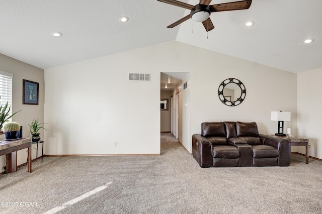 living area featuring visible vents, light colored carpet, lofted ceiling, and ceiling fan