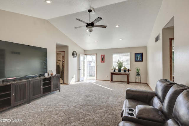 living room featuring a ceiling fan, visible vents, baseboards, lofted ceiling, and light colored carpet