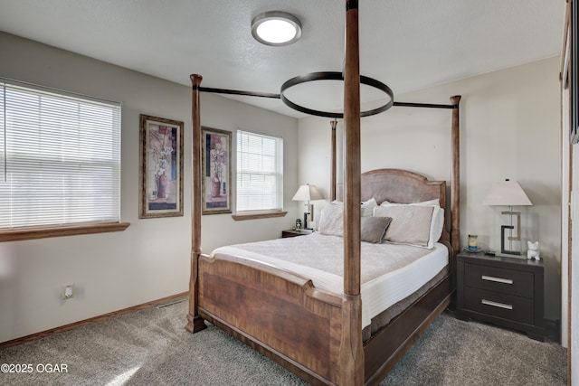 carpeted bedroom with a textured ceiling and baseboards