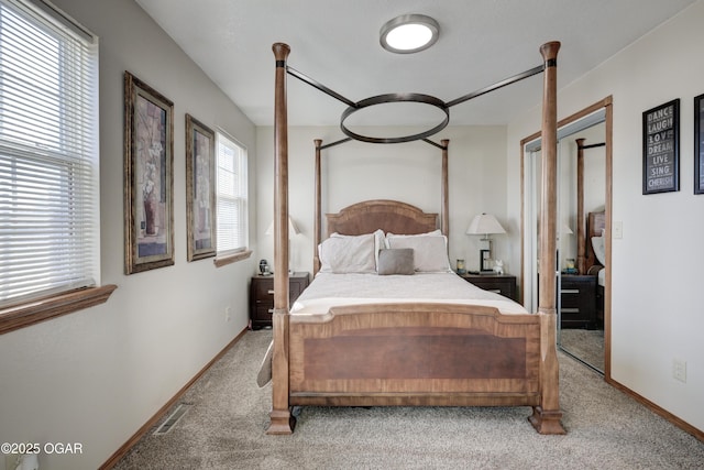 bedroom with baseboards, visible vents, and carpet floors