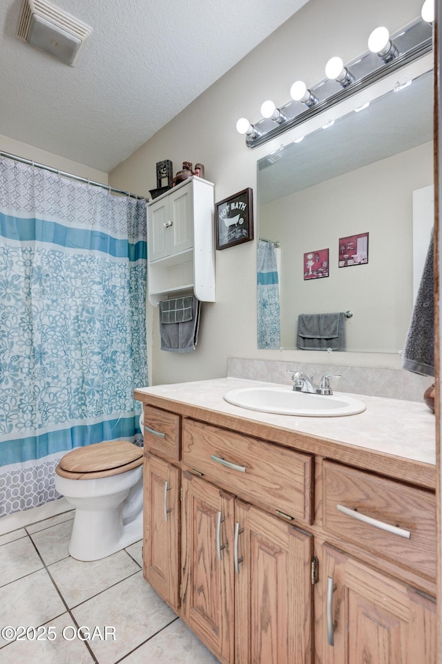 full bath featuring vanity, visible vents, tile patterned flooring, a textured ceiling, and toilet