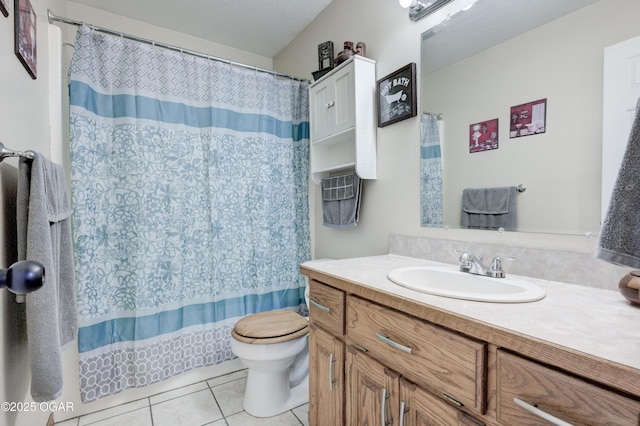 bathroom with vanity, tile patterned floors, curtained shower, and toilet