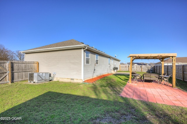 view of yard featuring central AC unit, a fenced backyard, and a patio area