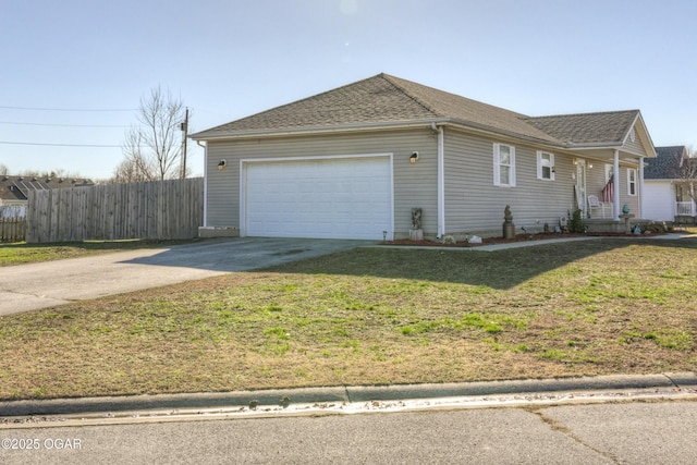 view of front of house with a front lawn, driveway, fence, an attached garage, and a shingled roof