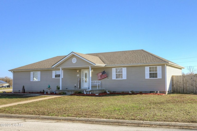 ranch-style home featuring roof with shingles, covered porch, a front yard, and fence