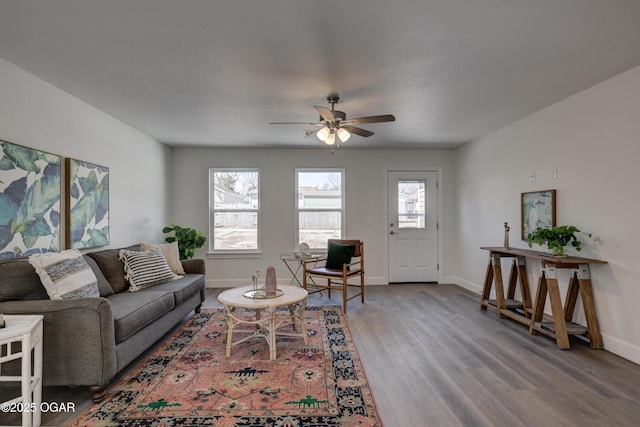 living room featuring plenty of natural light, wood finished floors, and baseboards