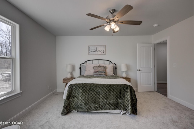 carpeted bedroom with ceiling fan and baseboards