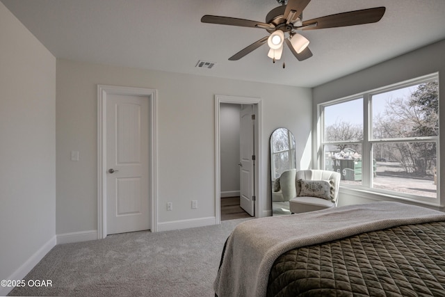 bedroom with visible vents, carpet floors, baseboards, and a ceiling fan