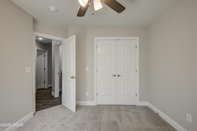 unfurnished bedroom with a closet, baseboards, and carpet flooring