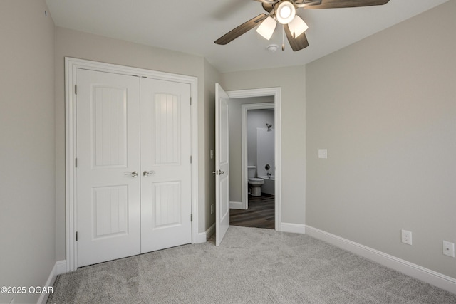 unfurnished bedroom with a closet, baseboards, and carpet