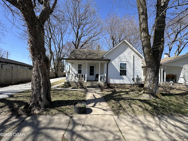 view of front facade with a porch and fence