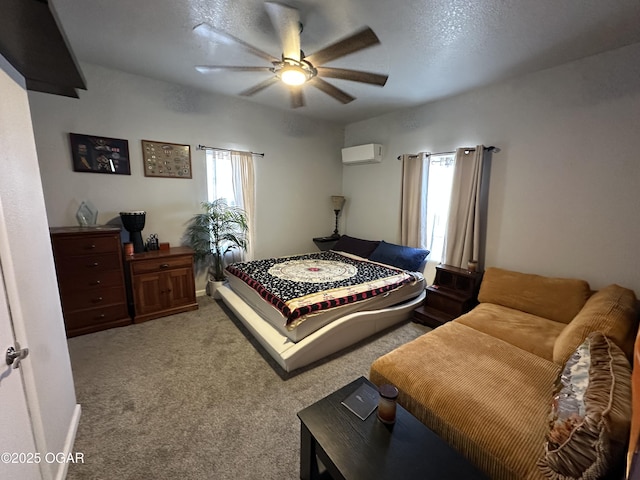 bedroom with ceiling fan, an AC wall unit, baseboards, and light carpet