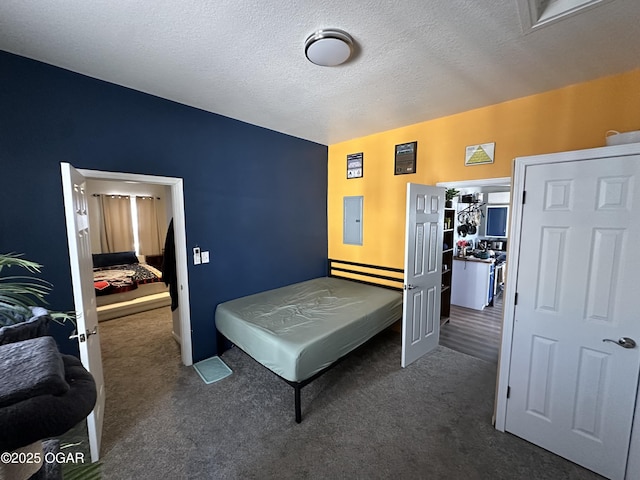 carpeted bedroom with electric panel and a textured ceiling