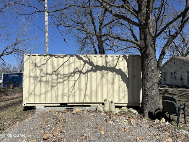 view of side of home featuring an outbuilding