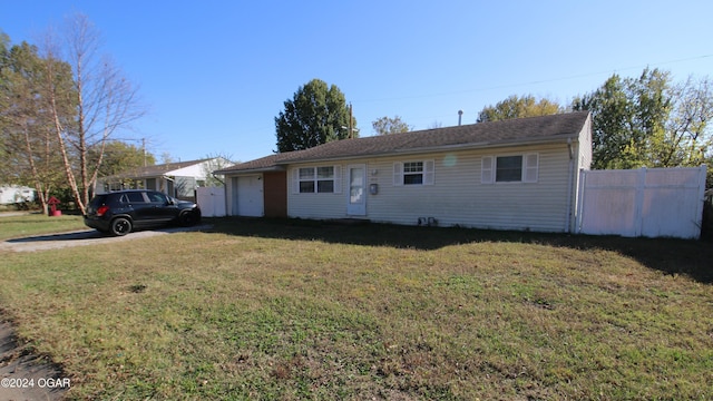 single story home with a garage, a front yard, and fence