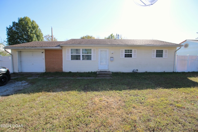 ranch-style house with fence, driveway, an attached garage, entry steps, and a front lawn