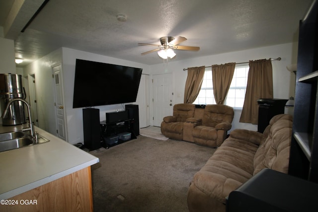 carpeted living area featuring a sink, a textured ceiling, and ceiling fan