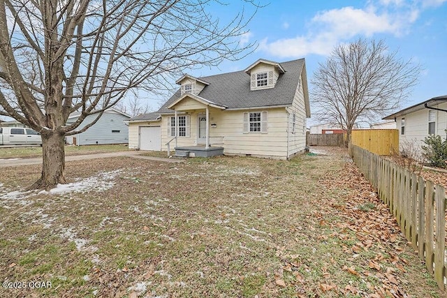 view of front of house with an attached garage, a shingled roof, and fence