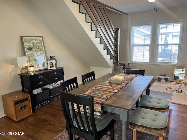 dining space featuring stairs and dark wood finished floors