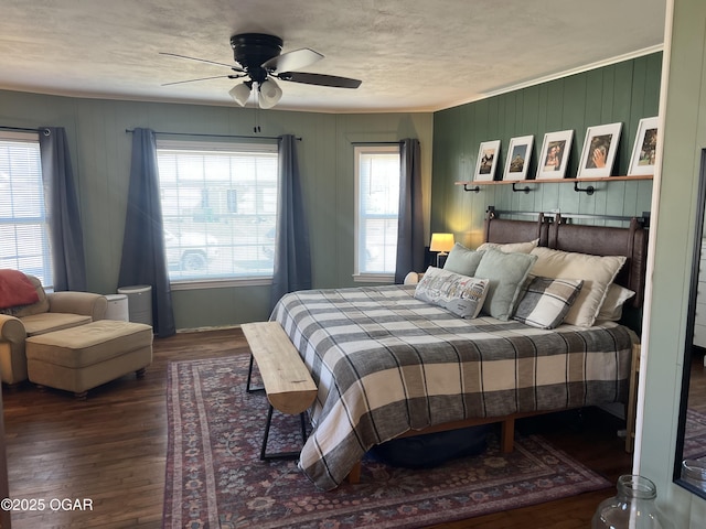 bedroom featuring multiple windows, wood finished floors, and ceiling fan