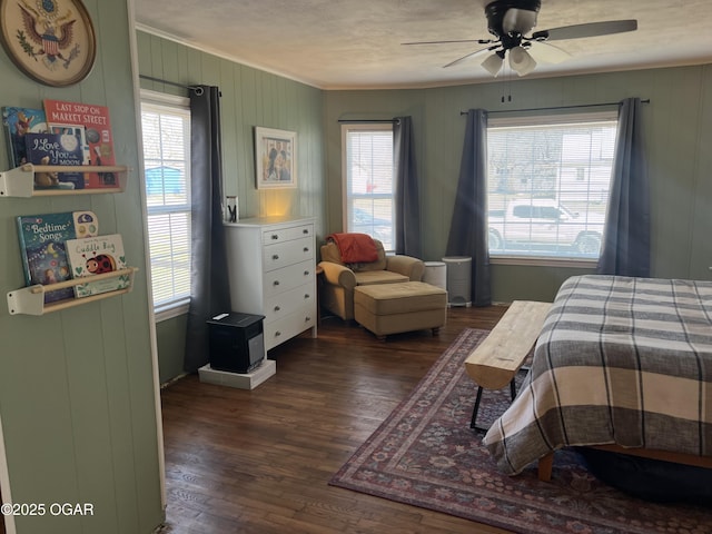 bedroom with ornamental molding, dark wood-style floors, multiple windows, and ceiling fan