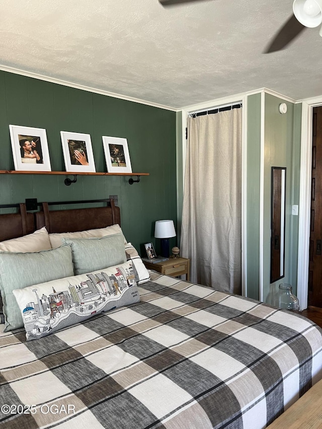 bedroom with wood finished floors, ornamental molding, and a textured ceiling