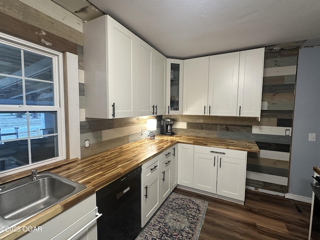 kitchen featuring dishwasher, wooden counters, dark wood finished floors, glass insert cabinets, and white cabinetry