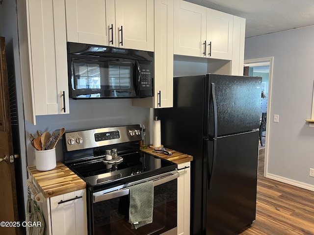 kitchen with white cabinetry, dark wood finished floors, black appliances, and butcher block counters