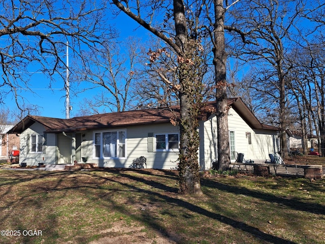 back of house with a lawn