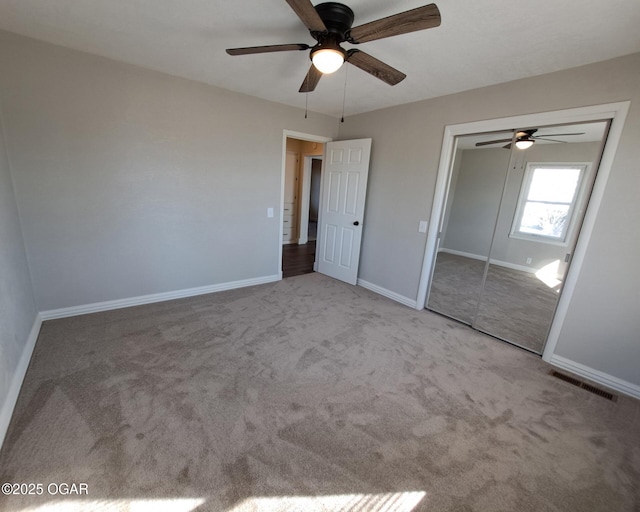 unfurnished bedroom featuring a closet, visible vents, baseboards, and carpet floors