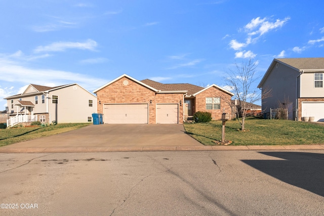 view of front of house with a front lawn, an attached garage, brick siding, and concrete driveway