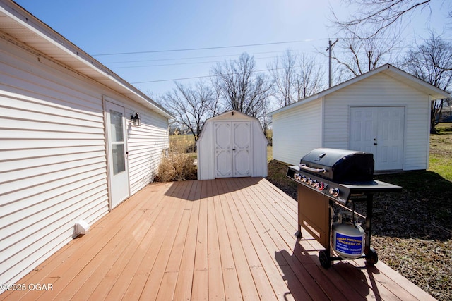 wooden deck featuring an outbuilding, area for grilling, and a storage shed