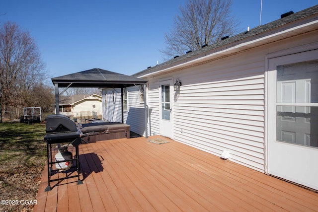 wooden deck with a gazebo, a covered hot tub, and grilling area