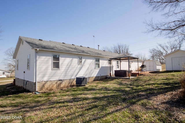 back of house with a lawn, a gazebo, a storage shed, an outdoor structure, and crawl space