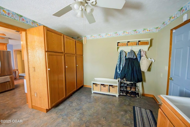 mudroom featuring baseboards, a textured ceiling, and a ceiling fan