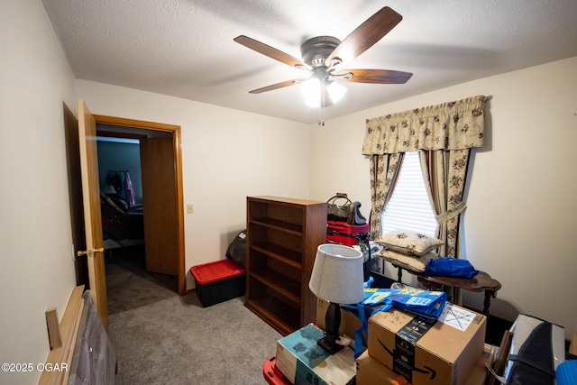 interior space featuring a textured ceiling and a ceiling fan