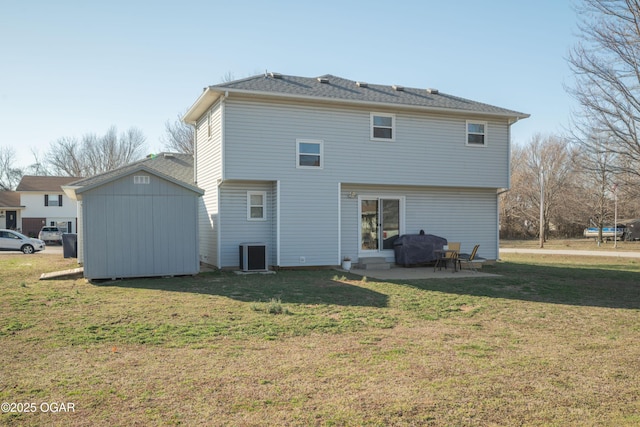 back of house featuring a storage unit, an outbuilding, a patio, a yard, and central AC unit