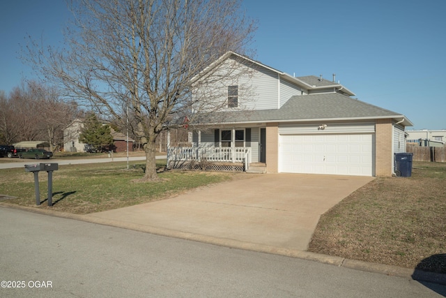 traditional home featuring a front yard, a porch, an attached garage, concrete driveway, and brick siding