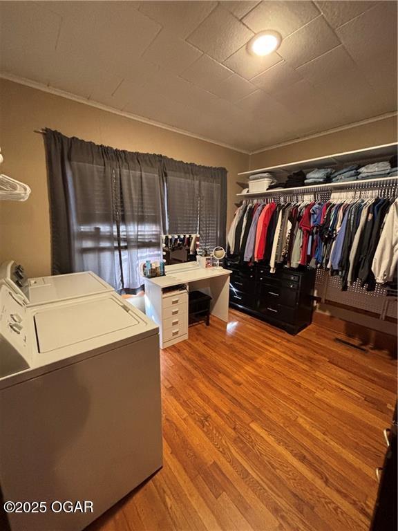 spacious closet featuring washer / clothes dryer and wood finished floors