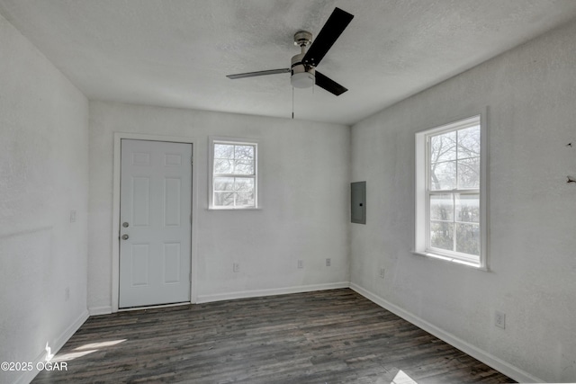 unfurnished room featuring baseboards, a healthy amount of sunlight, and wood finished floors